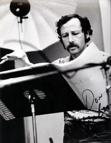 An archival photo of a major film scoring stage with a full orchestra.